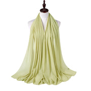 Light green scarf on a mannequin against a white background