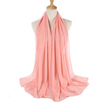 Pink scarf on a mannequin with a white background