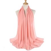 Pink scarf on a mannequin with a white background