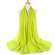 Lime green scarf on a mannequin with a white background