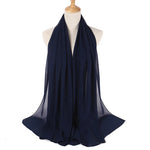 Navy blue scarf on a mannequin against a white background