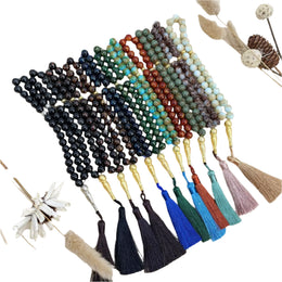 Set of beaded necklaces with tassels on a textured surface