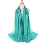 Turquoise scarf on a mannequin with a white background