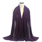 Purple scarf draped over a mannequin on a white background