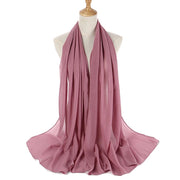 Pink scarf on a mannequin with a white background