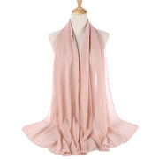 Pink scarf on a mannequin with a white background