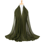 Green scarf on a mannequin with a white background