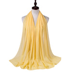 Yellow scarf on a mannequin with a white background