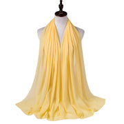 Yellow scarf on a mannequin with a white background