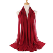 Red scarf on a mannequin with a white background