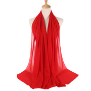 Red scarf on a mannequin with a white background