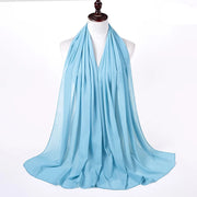Light blue scarf on a mannequin with a white background