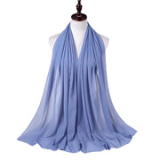 Light blue scarf on a mannequin against a white background