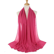 Pink scarf on a mannequin with a white background
